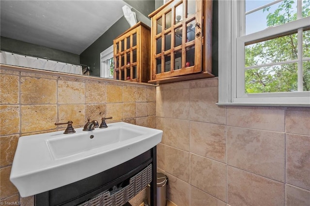 bathroom with vanity and tile walls
