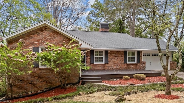 ranch-style home with a garage, brick siding, a chimney, and a shingled roof