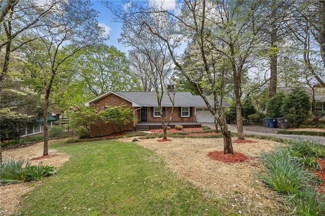 single story home with a front yard, brick siding, an attached garage, a chimney, and driveway
