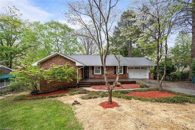 ranch-style house with brick siding, a garage, and aphalt driveway