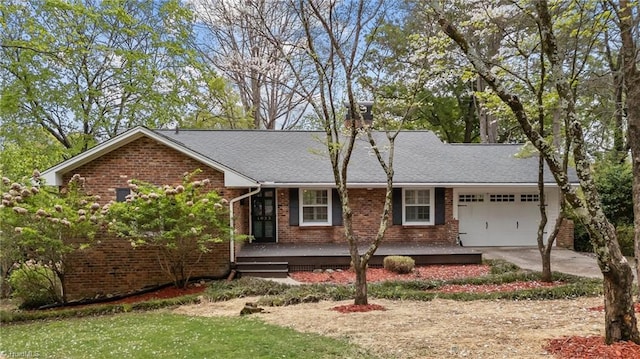ranch-style house with a garage, brick siding, concrete driveway, and a shingled roof