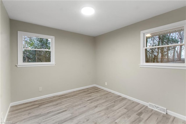 empty room with a healthy amount of sunlight and light wood-type flooring