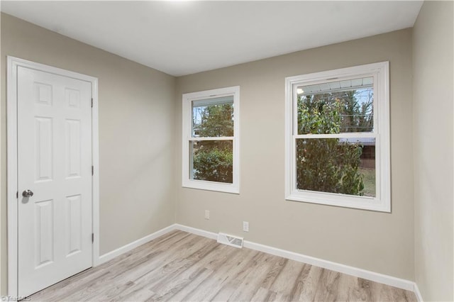 empty room with light hardwood / wood-style floors