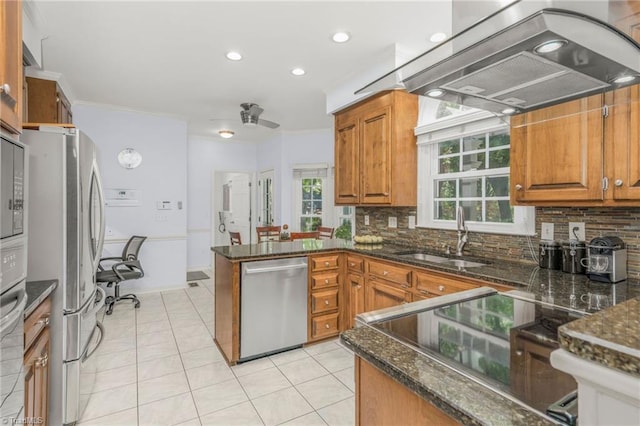 1018 Riverbend Dr, Advance, NC 27006 - kitchen featuring appliances with stainless steel finishes, island exhaust hood, a peninsula, brown cabinets, and tasteful backsplash