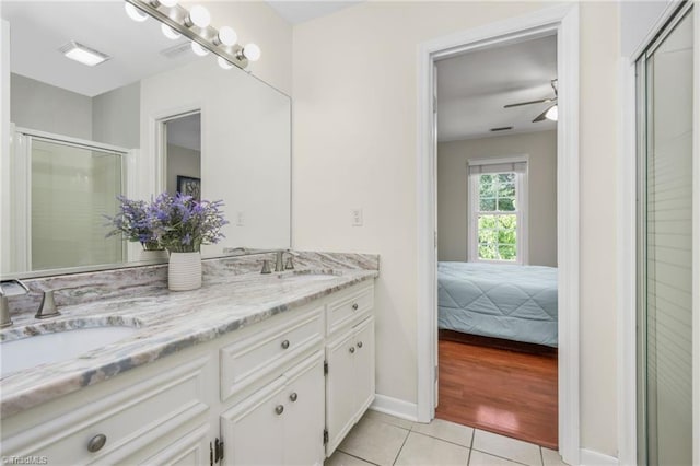 1018 Riverbend Dr, Advance, NC 27006 - bathroom featuring tile patterned floors, double vanity, a stall shower, ceiling fan, and ensuite bath