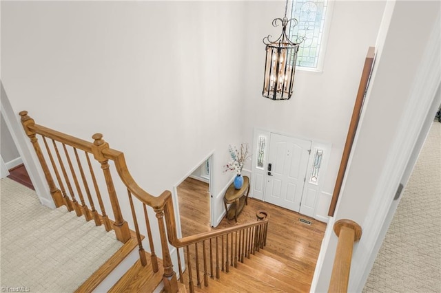 1018 Riverbend Dr, Advance, NC 27006 - entrance foyer featuring a chandelier, carpet, a high ceiling, and wood finished floors