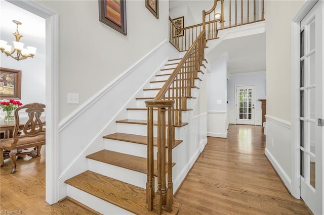 1018 Riverbend Dr, Advance, NC 27006 - stairway with a chandelier, wood finished floors, and ornamental molding