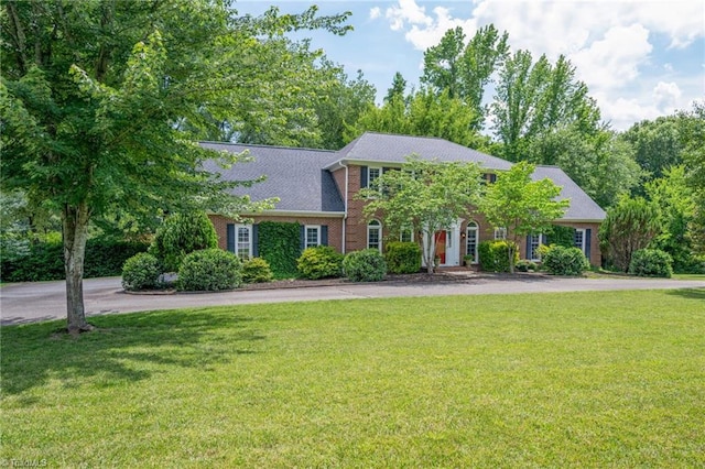 1018 Riverbend Dr, Advance, NC 27006 - colonial house featuring a front lawn and brick siding