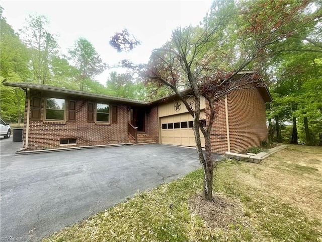 2892 NC Highway 700, Pelham, NC 27311 - view of front of home with brick siding, driveway, and a garage