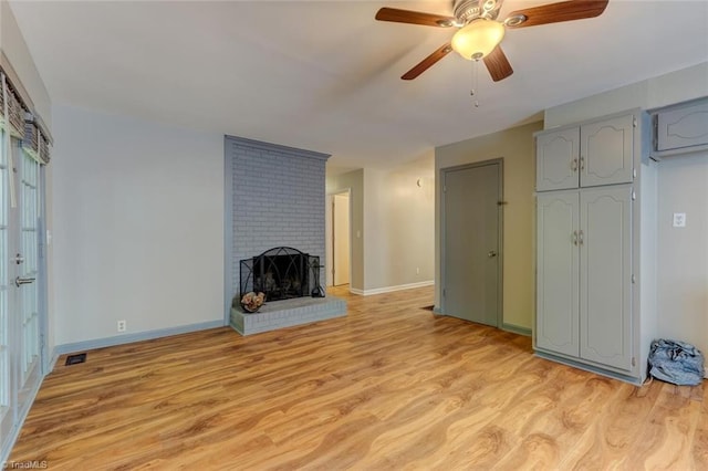 2892 NC Highway 700, Pelham, NC 27311 - unfurnished living room featuring visible vents, a fireplace, light wood-style floors, baseboards, and ceiling fan