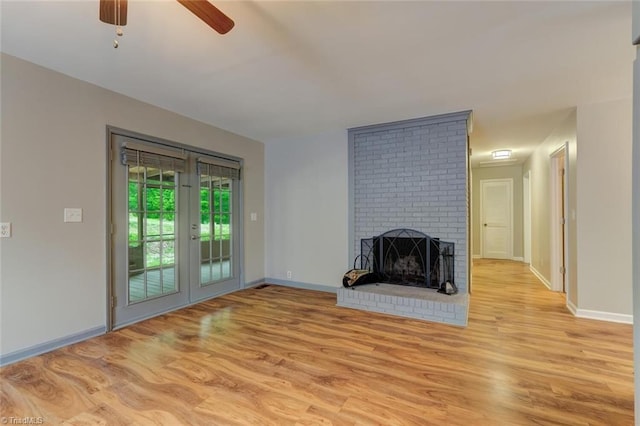 2892 NC Highway 700, Pelham, NC 27311 - unfurnished living room with baseboards, ceiling fan, a brick fireplace, and wood finished floors