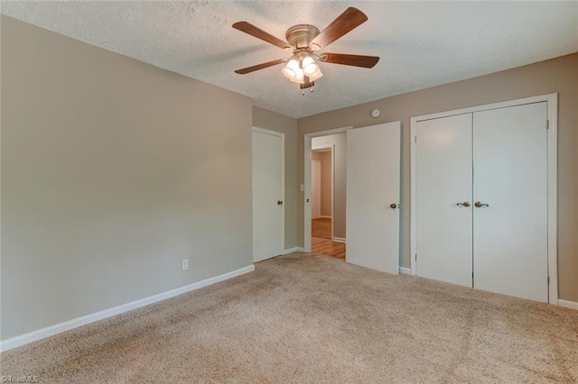 2892 NC Highway 700, Pelham, NC 27311 - unfurnished bedroom featuring a closet, baseboards, ceiling fan, a textured ceiling, and carpet