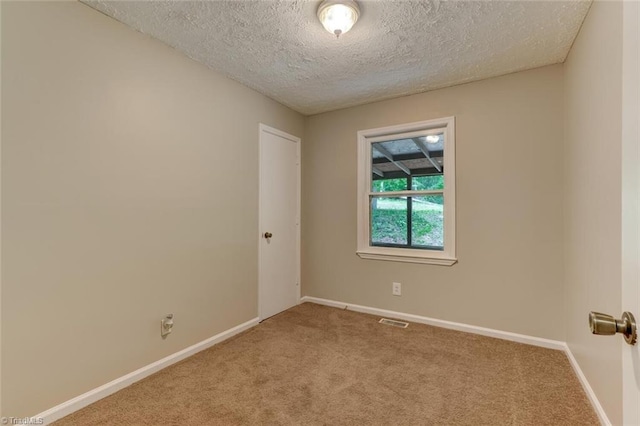 2892 NC Highway 700, Pelham, NC 27311 - unfurnished room featuring carpet flooring, a textured ceiling, visible vents, and baseboards