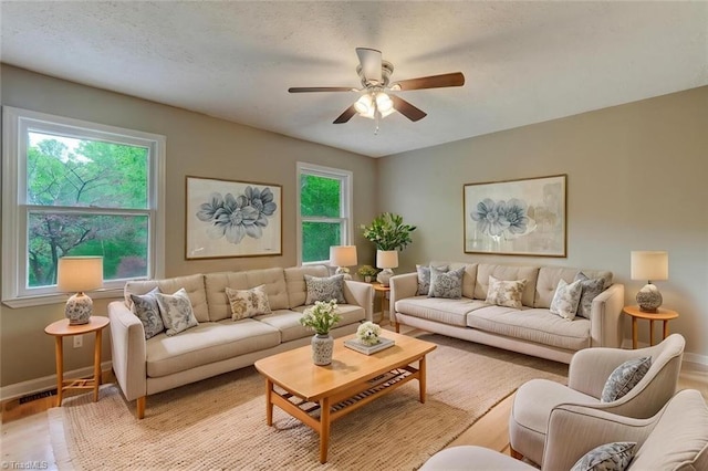2892 NC Highway 700, Pelham, NC 27311 - living room with baseboards, a ceiling fan, and light wood finished floors