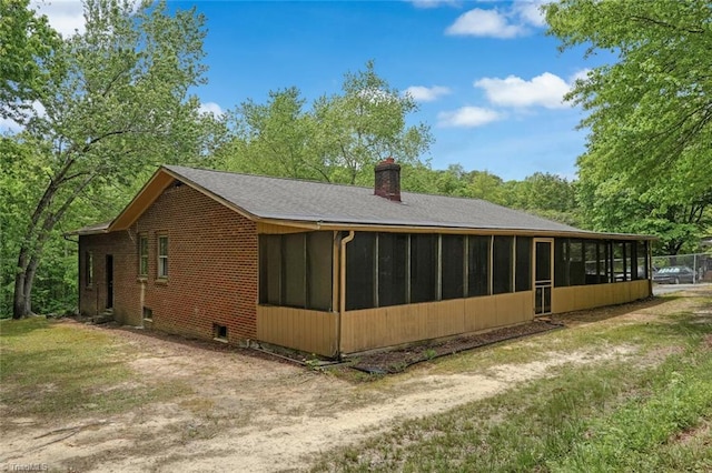 2892 NC Highway 700, Pelham, NC 27311 - view of side of home featuring roof with shingles, a chimney, a sunroom, and brick siding