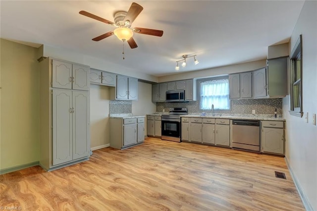 2892 NC Highway 700, Pelham, NC 27311 - kitchen featuring visible vents, gray cabinets, tasteful backsplash, a sink, and stainless steel appliances