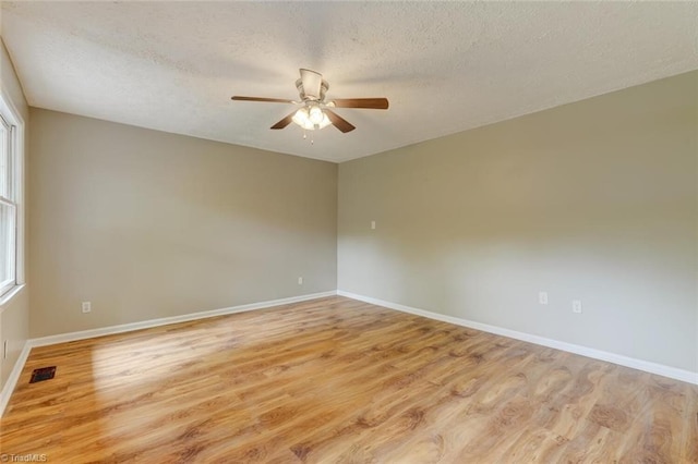 2892 NC Highway 700, Pelham, NC 27311 - unfurnished room featuring visible vents, baseboards, a textured ceiling, a ceiling fan, and light wood-style flooring