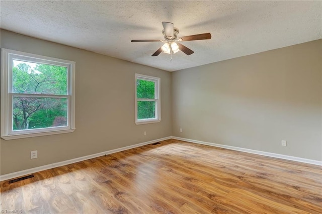 2892 NC Highway 700, Pelham, NC 27311 - unfurnished room featuring visible vents, baseboards, light wood-style floors, a textured ceiling, and a ceiling fan