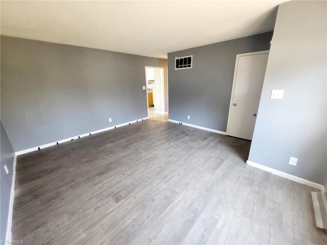 spare room featuring light hardwood / wood-style flooring