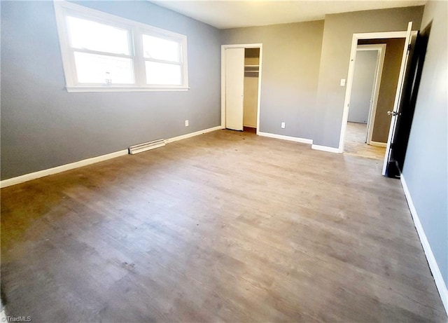 unfurnished bedroom featuring light wood-type flooring and a closet