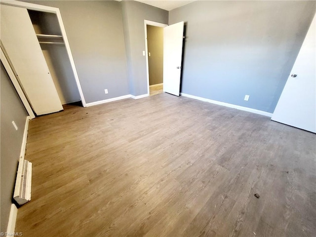 unfurnished bedroom featuring a closet and light hardwood / wood-style flooring