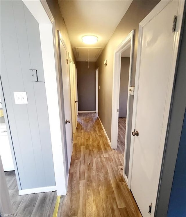 corridor with light hardwood / wood-style flooring