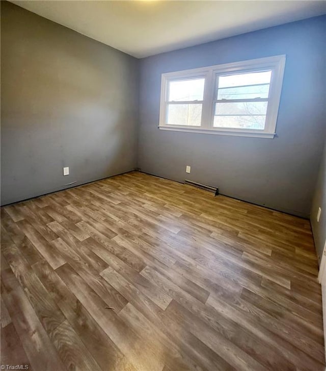 spare room with light hardwood / wood-style floors