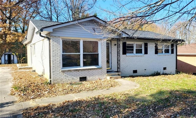 view of front of property with a shed