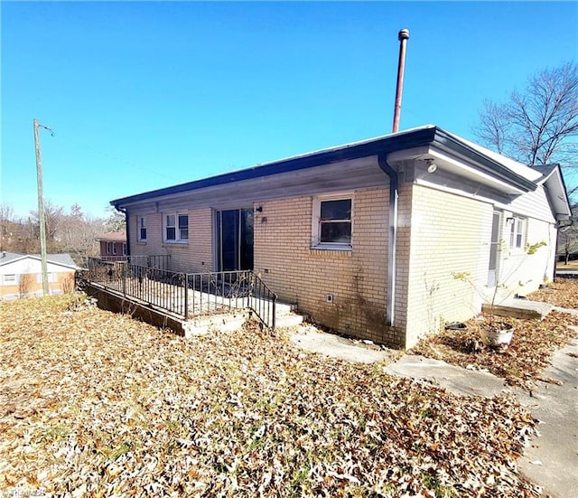 rear view of house featuring a deck