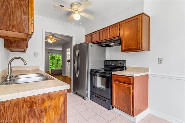kitchen featuring black range with electric cooktop, under cabinet range hood, a sink, ceiling fan, and light countertops