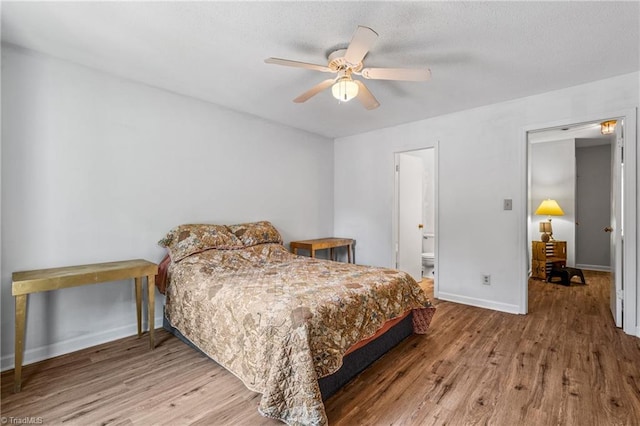 bedroom featuring wood finished floors, baseboards, and a ceiling fan