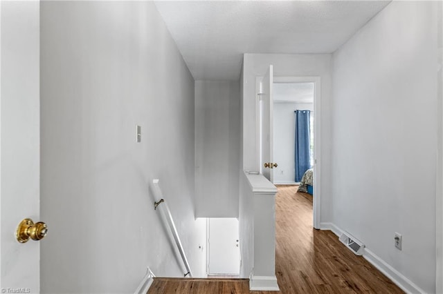 stairway featuring wood finished floors and baseboards