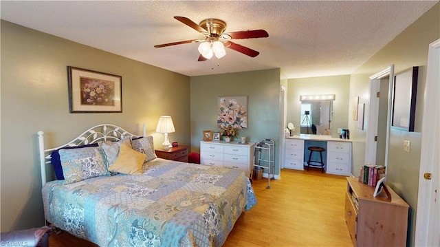 bedroom with light wood-style floors and a ceiling fan
