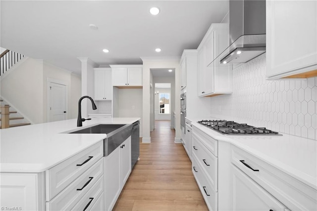 7815 Michaelis St, Greensboro, NC 27455 - kitchen with wall chimney range hood, appliances with stainless steel finishes, a sink, decorative backsplash, and recessed lighting