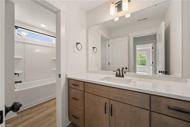 7815 Michaelis St, Greensboro, NC 27455 - full bath featuring vanity, wood finished floors, and washtub / shower combination
