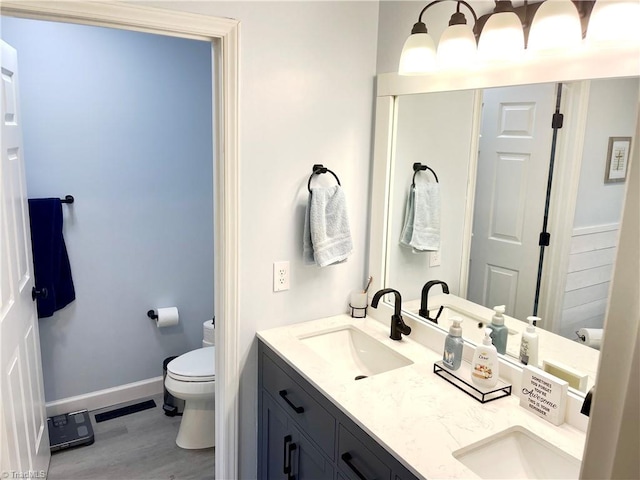 940 Huntington Run Ln, Kernersville, NC 27284 - bathroom featuring toilet, double vanity, and wood finished floors