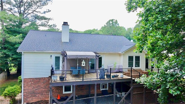 940 Huntington Run Ln, Kernersville, NC 27284 - back of house with a chimney, brick siding, and a wooden deck