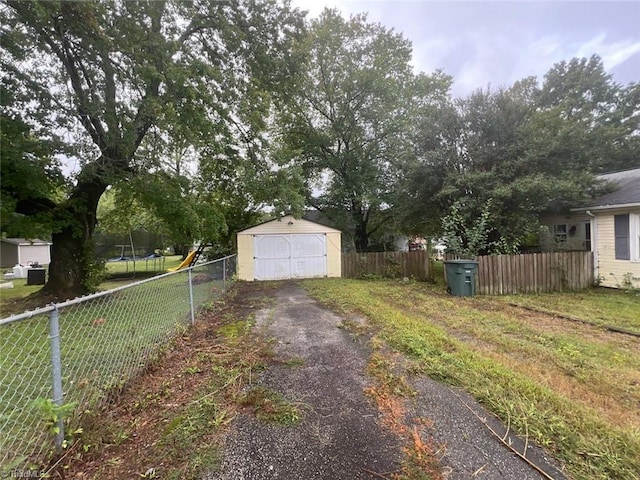 view of yard with a trampoline and a shed