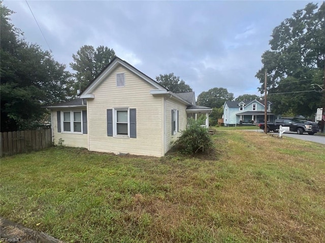 view of side of property with a lawn