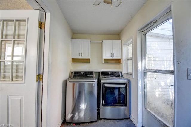 laundry area with cabinets, a healthy amount of sunlight, washer and clothes dryer, and ceiling fan