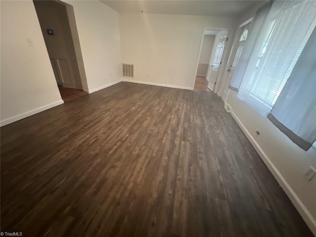 empty room featuring dark hardwood / wood-style flooring