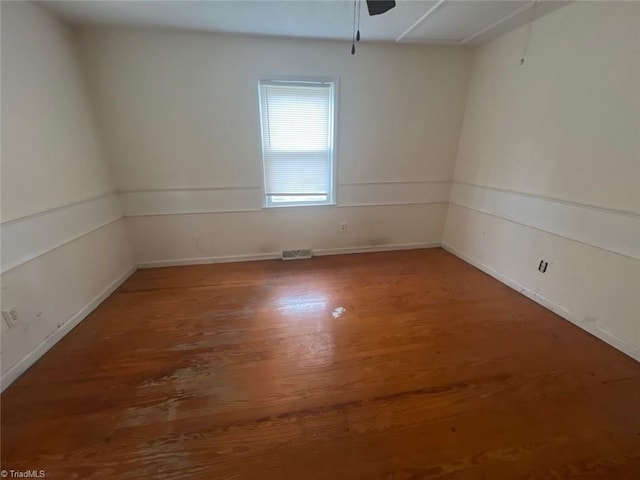 empty room featuring hardwood / wood-style flooring and ceiling fan