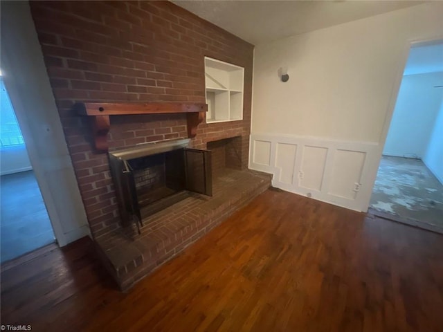 unfurnished living room with a fireplace and dark hardwood / wood-style flooring