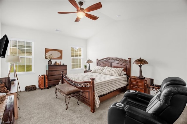 1009 Cannonade Dr, Whitsett, NC 27377 - carpeted bedroom with vaulted ceiling and a ceiling fan