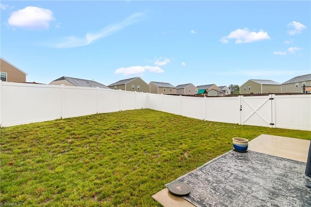 1009 Cannonade Dr, Whitsett, NC 27377 - view of yard featuring a patio area, a residential view, and a gate