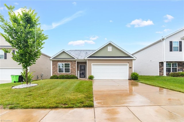 1009 Cannonade Dr, Whitsett, NC 27377 - view of front of property featuring an attached garage, a front yard, driveway, and stone siding