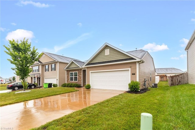 1009 Cannonade Dr, Whitsett, NC 27377 - traditional-style home featuring an attached garage, concrete driveway, and central AC unit