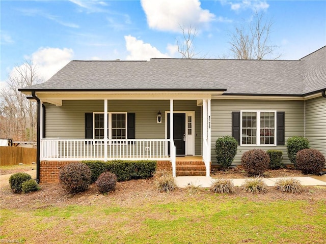 ranch-style house with covered porch and a front lawn