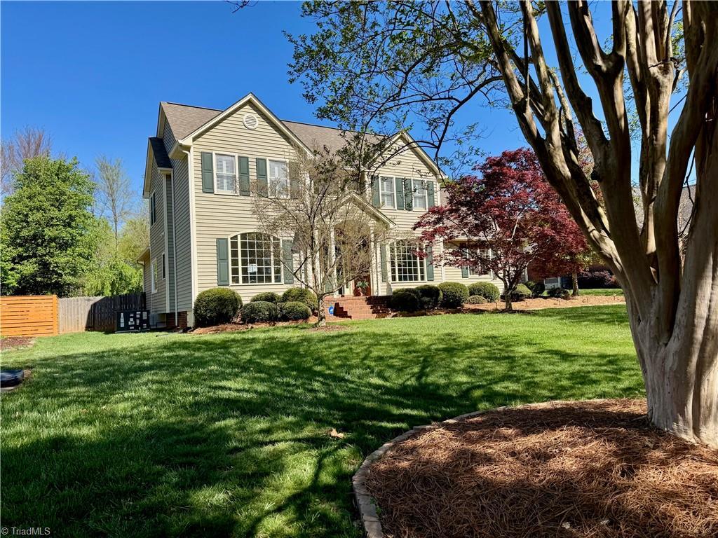 traditional-style home featuring fence and a front lawn