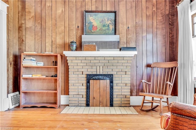 1112 Hamilton St, High Point, NC 27262 - detailed view of a brick fireplace, wood finished floors, and wooden walls
